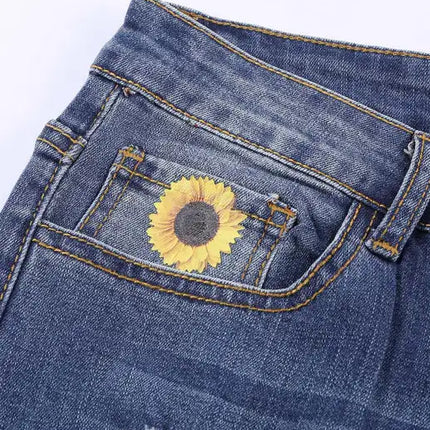 Jeans de cintura alta desgastados con estampado de girasol y patchwork de leopardo 