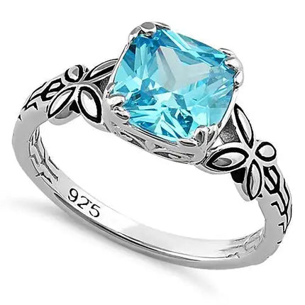 Anillo con circonita azul aguamarina con talla cojín y mariposa gemela