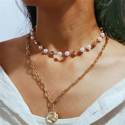 Alternating gold bead and pearl necklace with gold chain and coin necklace